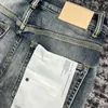 Jeans da uomo viola Pantaloni con foro blu di marca di moda lavati con inchiostro spruzzato