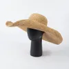 Il designer casual Rafia lavorato a mano all'uncinetto sovrasta i cappelli parasole da spiaggia all'aperto