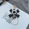 Keychains Luxury Black Camellia Genuine Leather Flower Keychain Letter Umbrella Pendant Car Key Chain Ring For Bag