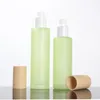 Bottiglie di stoccaggio lozione/bottiglia spray imballaggio da 120 ml di vetro verde/blu con coperchio a grana in legno