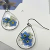 Boucles d'oreilles étalon rétro ovales transparentes naturelles à fleurs sèches résine contracte de la résine originale des femmes bijoux pour femmes