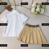 子供服の子供セット高品質のベビードレス夏2PCSポロカラーと格子縞のスカートの弾力性のあるカフス新製品