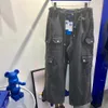 Ader Mens Pants Streetwear Hip Hop مطبوع بنطلون غير رسمي على الجعوب متعددة الجيوب المستقيمة زر الزواج الفضفاض