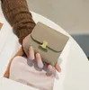 Оптовая женская кошелька Коротко-коврик Трехкратный кошелек американский/корейский складывание маленьких изменений многоцелевое кошелек