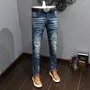 Męskie dżinsy streetwear moda moda retro niebieski splatany rozciąganie szczupła motocyklista Homme Painted Designer Hip Hop Ripped Pants Hombre