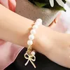 Bracelets porte-bonheur L008 doux Pulseras Bowknot simulé perle Bracelet perlé pour les femmes élastique arc bijoux de mariage bracelets