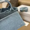 Arco Bolsos de hombro intreccio bolso de mano superior Lona de mezclilla Un solo bolsillo con cremallera desmontable tejido suave tendencia de la moda lujos simples Bolso de mano de mujer