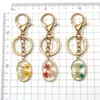 Keychains Oval Natrual Real Dried Flower Daffodils Petal Resin Pendant Key Chain Lobster Clasp Buckle Dangle Keyring Bag Car Holder