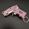 Schlüsselanhänger Legierung Kunststoff M1 Mini Anhänger faltbare Gummibandpistole kann für 6 aufeinanderfolgende Kinderspielzeug-Soft-Bullet-Pistole verwendet werden.
