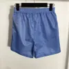 Tvådelade byxor för damer sommar fritidskostym kortärmad luvtröja Elastiska shorts med triangelmärke svettdräkt