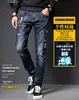 Jeans da uomo Designer Autunno moda uomo jeans stampati ricamati con buco rotto pantaloni casual slim con piedi piccoli Z5R8