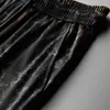 Męskie spodenki Kamuflaż jakość europejskich spersonalizowanych brązowców luźnych i oddychających w środku w letnim trendów swobodne spodnie
