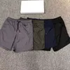 Pantaloncini firmati Pantaloni corti da jogging da palestra da uomo con intranet Pantaloni sopra il ginocchio Tasche con cerniera sul cavallo basso Etichette ricamate bianche Pantaloni corti da spiaggia