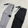 Taş Genel Mens Kargo Pantolon Marka Tasarımcı Sezon İki Renkler Adası Bahar Naylon Yansıtıcı İnce Işık Joggers Street Giyim Pantolon Tidal Akış Tasarımı 63ESS