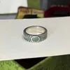 20% korting op 2023 Nieuwe luxe hoogwaardige mode -sieraden voor marmerbruine en groene glazuurrandgravuring Interlocking dubbele ring