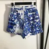 Survêtements pour femmes 7.20 Haute Qualité Imprimé Bleu Sexy Hors Épaule À Manches Courtes Chemisier Arc Taille Élastique Pantalon À Jambes Larges Shorts Ensemble FemmesFemmes