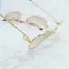 Designer Men e feminina Casal de praia de praia Os óculos de sol 20% do retro oval homens metal metal de óculos de sol elegante masculino clássico de condução de barreira óculos de óculos da marca de óculos