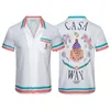 Novas camisas masculinas Casablanc-s Lucid Dreams Island Cenário Cor Temperamento Cetim Manga Curta Vestido Camisa Variedade