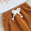 Zestawy odzieży Summer Baby Boy 2pcs Ostra Ubrania Krótkie rękawie litera królicza nadruk topy Shamrock Jogger Pants Zestaw odzieży maluchowe 230322