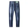 Wiosna/lato 2023 Niebieskie dżinsy popularna zielona skórzana etykieta dekoracyjna elastyczna Slim Fit Pants Mężczyźni