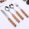 Set di stoviglie Set 7 pezzi/set Manico in bambù Coltello Forchetta Utensili da cucina in acciaio inossidabile Qualità di resistenza alle alte temperature