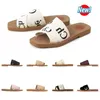 2023 Tofflor Designer Kvinnor Woody Flat Mules Sandaler Slides Segel Canvas Rosa Blå Vit Svart Kvinnor Utomhus Beach Tofflor skor modeplattform sandaler