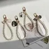 Porte-clés en chaîne de perles pour filles et femmes, 4 styles, pendentif de sac à main, décoration, accessoires de mode, vente en gros