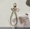 Porte-clés en chaîne de perles pour filles et femmes, 4 styles, pendentif de sac à main, décoration, accessoires de mode, vente en gros