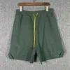 Ins Summer Moda europea y americana Br Pantalones deportivos para jóvenes Pocket Drawcord Street Hip Hop Loose Men's Quarter Shorts
