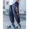 Pantalons pour hommes lettre impression Streetwear Harajuku vêtements survêtement ample à la mode HipHop Cargo salopette Leggings surdimensionné pantalon