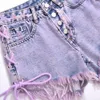 Kvinnors höga midja tvättade burrs minikvinnor båda sidor slipsar lila kort gata sexig mode tassel denim shorts jeans z0505
