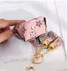 Lederen sleutelhangers ringen sieraden bruine bloem plaid kwast munt portemonnee hangende mode mode mini opbergzak charm sleutelhangers accessoires 7 kleuren