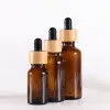 Flacon compte-gouttes en verre ambré en gros avec couvercles en bambou Bouteilles d'huiles essentielles Flacons d'échantillons pour liquides cosmétiques de parfum 15 ml 20 ml 30 ml 50 ml 100 ml