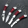 Mini Keychain Folding Knife Steel Blade Pocket Knife Små hängande fällbara knivar Multifunktionellt trähandtag Utility Knife