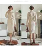 Casual Dresses Mid-längd aprikos stickad klänning för kvinnor 2023 Autumn Retro Turtleneck Twist Sticking Long Sleeve Winter Basic