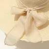 Cappelli a tesa larga Secchiello 15CM Paglia da spiaggia per donna Semplice pieghevole Estivo Cappello da sole Moda piatto Brom Bowknot Protezione UV Panama 230517