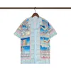 2023 Designer de luxo Designer de moda de verão Men's Shirt Men's Europe Europa Paris Camisa de algodão de alta qualidade Logotipo de chama feminina Impressão de manga curta de manga curta Top M-3xl