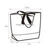 Geschenkpapier 5 Stück weiße Pappe mit schwarzem Rahmen Shop-Papiertüte für Werbekleidung Tragbare Tragetasche Geschäftsverpackung Baggift Drop Deli Dhlo7