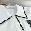 Женские блузкие рубашки Дизайнер 2023 Новый высокий издание роскошная мода классическая контрастная краска с бриллиантовой рубашкой Свободная повседневная универсальная топ 1VVX