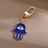 Creative Ethnic Hand of Fatima keychain Pendant Blue Devil's Eye Alloy Hollow Jewelry Car Bag Keychains Accessories