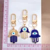 Creative Ethnic Hand of Fatima keychain Pendant Blue Devil's Eye Alloy Hollow Jewelry Car Bag Keychains Accessories