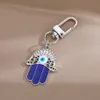 Creative Ethnic Hand of Fatima keychain Pendant Blue Devil's Eye Alloy Hollow Jewelry Car Bag Keychains Accessories