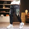 Pantaloni da uomo Cargo Fashion Hip Hop Pantaloni multitasche Trendy Streetwear Graffiti Pantaloni della tuta Pantalones Pantaloni con coulisseUomo