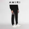 Abbigliamento firmato Amires Pant Amies Primavera estate Nuovo slogan Lettera Stampa Pantaloni lunghi Casual Versatile Uomo Donna Coulisse Piedi Pantaloni da guardia Moda di lusso Cas