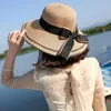 Chapéus largos Brim Ribbon Bowknot Women Straw Hat Top Top Sun feminino elegante Tour da praia de viagens ao ar livre macia e elegante