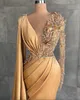 2023 Sexy Gold Evening Dresses Wear Jewel Neck Illusion Mermaid Side Split Lace Appliques Crystal Beaded Pearls Long Sleeves Feather Formal Party Dress Prom Gowns