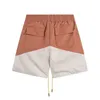 Designer Kort Mode Fritidskläder Strandshorts Rhude Bokstavstryck Tvåfärgssömmar High Street Dragsko Träningsbyxor Shorts Lösa Casual Byxor Sommar Jogg