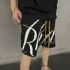 Designer Kort Mode Fritidskläder Strandshorts Rhude Amerikanskt modemärke Letter Jacquard Stickad ylletråd Herr Dam Lös Sport 54 Shorts Sommar Jo