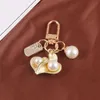 Key Rings Fashionable and Creative Cute Heart Shell Pearl Fairy Forest Letter Leaf Metal Car Keychain Bracket Student Bag Pendant Jewelry G230526