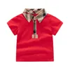 Härliga Baby Boys Girls T-shirts Summer Kids Kort ärm T-shirt Turn-Down Collar Barn Plaid Skjorta Child Tops Tees 1-6 år